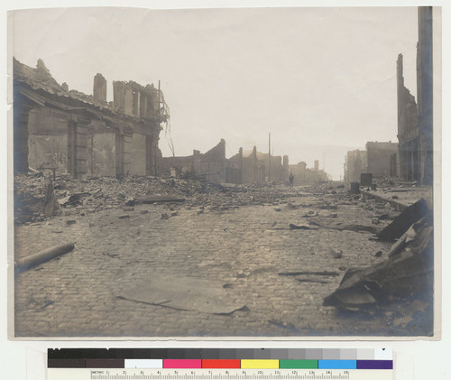 [Soldier in distance amid ruins. Unidentified location.]