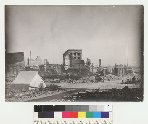 [Street scene, showing tent and reconstruction.]