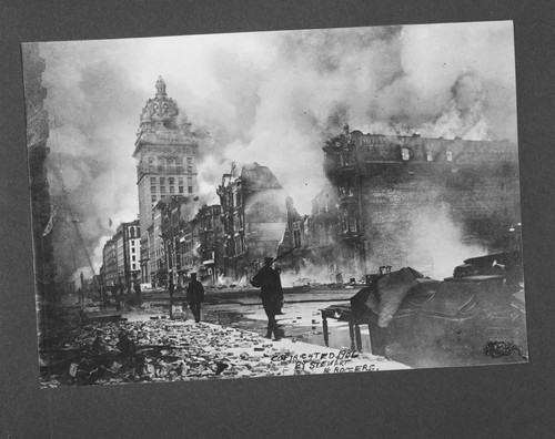 Looking down Market St. Call Building burning in distance. [caption on print: Emporium on fire. April 18, 1906.]