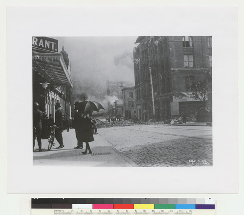 [Street scene showing girl with umbrella, unidentified location. No. 593.]