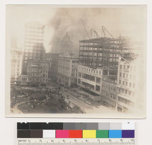 [View from above Union Square of fire burning in South of Market district. Looking southeast toward Call Building (center) and Market St.]