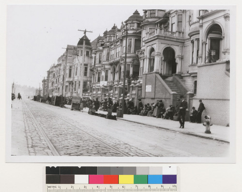 [Refugee line and street kitchens along unidentified street.]