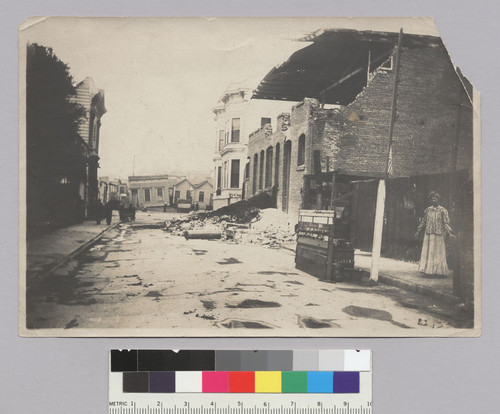 [Earthquake damage along unidentified street.]