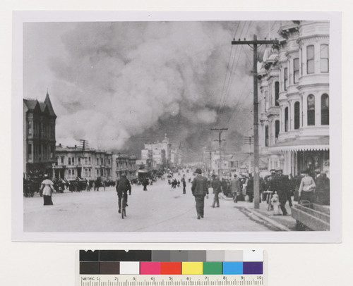 [People in street. Van Ness Ave.? Fire burning in distance.]