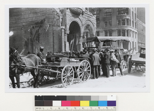 [Street scene, with men gathering at wagons. Sansome and Commercial Sts.? Pacific Mutual building and Italian American Bank in background?]