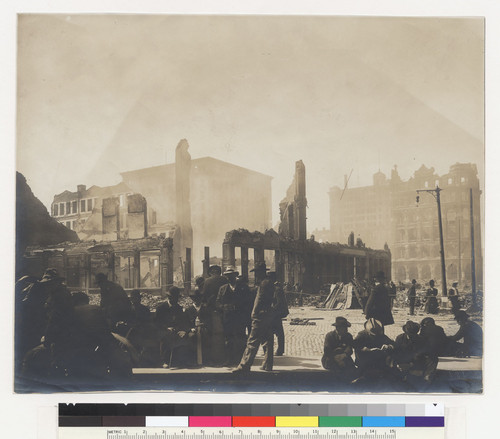 [Scene at Battery, Bush and Market Sts. Men seated at curb and at foot of Donahue Labor Monument.]