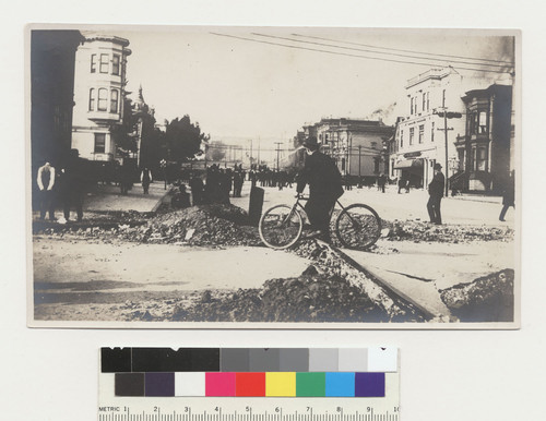 Van Ness Ave. [Subsided street in foreground; firefighting effort in distance.]