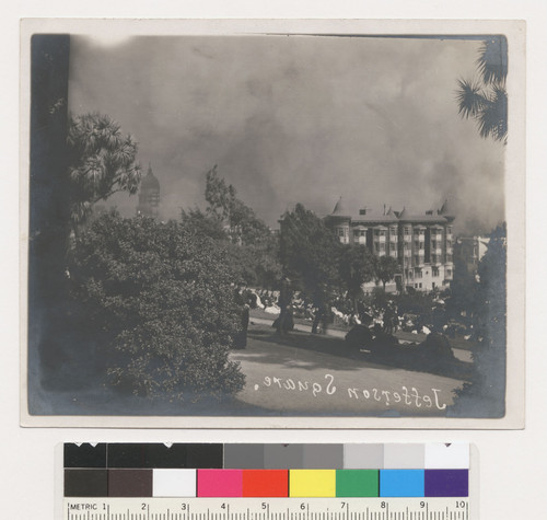 Jefferson Square. [Refugees gathering in park. Fire burning in distance.]