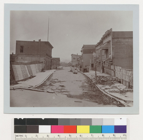 Dore St. [View showing debris and subsidence along street.]