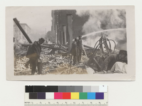 S.F. 1906. [Men at ruins; water jet from fire hose in background.]