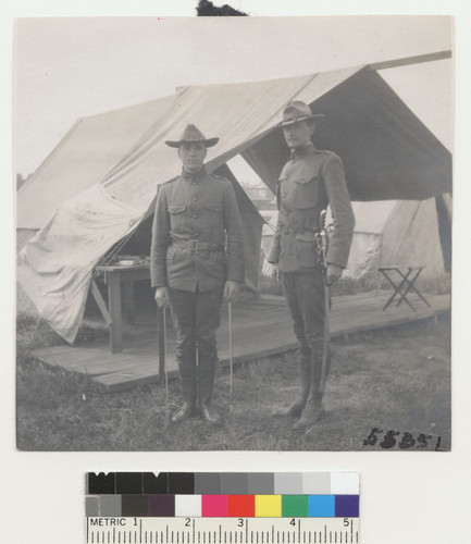 [Two soldiers posing by tent. Unidentified location.]