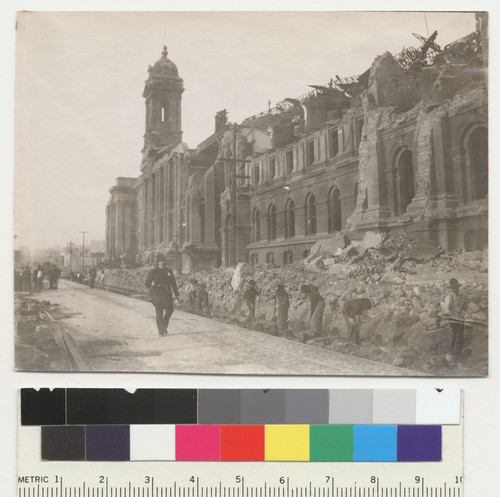 Looking side of City Hall. [Construction crew building temporary railroad tracks?]