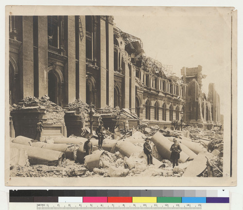 Fallen pillars of the City Hall. San Francisco. [Police officers posing among ruins.]