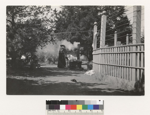 In G.G. Park [i.e. Golden Gate Park]. [Woman cooking in refugee camp.]