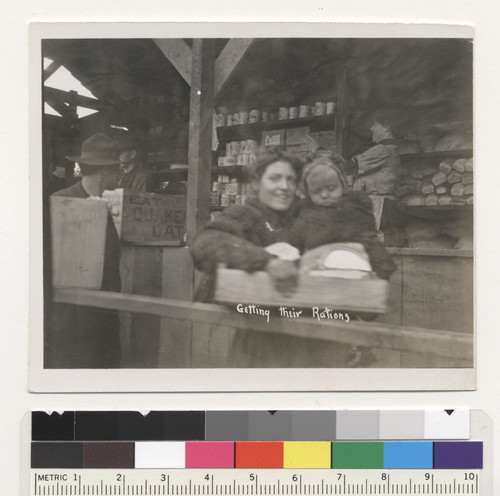 Getting their rations. [Refugees in relief station.]