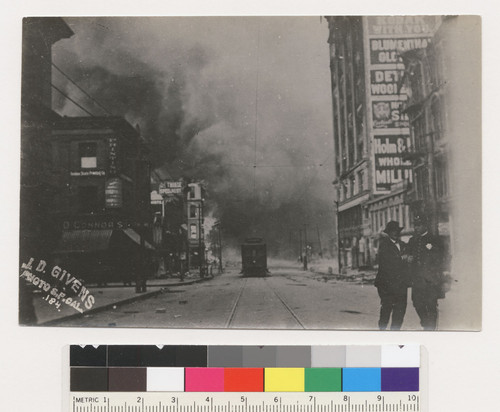 [Man and police officer. Fire burning in distance. Third St. between Market and Mission. No. 184.]