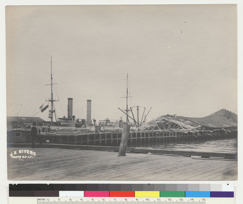 [View of damage along wharf. Man of War "New York" at pier. No. 137.]