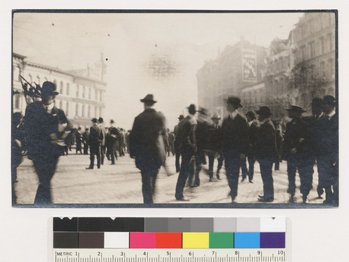 [Street scene showing crowd watching fire burn in distance. Market at Battery and Bush Sts.]