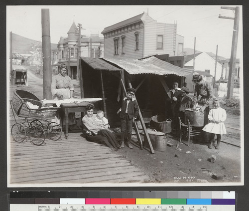 [Family at street kitchen.]