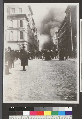 [Street scene of crowd gathered during fire.]