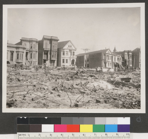 [Houses along Howard St. viewed from across ruined lots.]