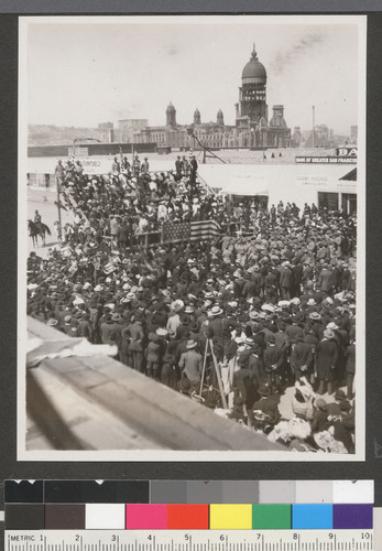 [Crowd gathered at unidentified event. Near Van Ness and Market Sts.?]