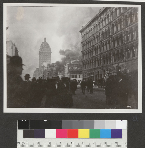 [Crowd on Market Street during fire. Call Building, left center; Emporium, right.]