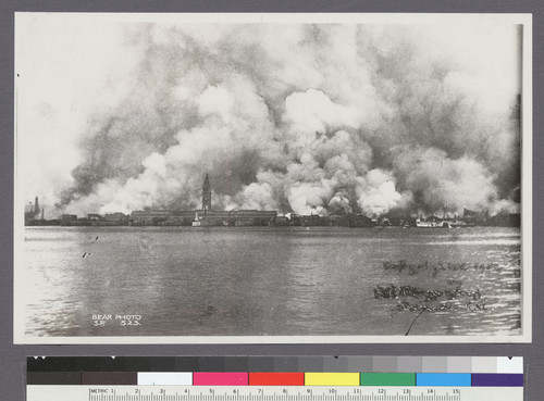 [View of city burning from San Francisco Bay. Ferry Building, left center.]