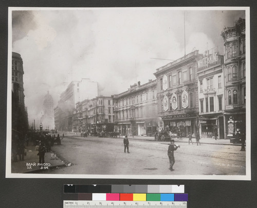 [View northeast along Market St. from Turk and Mason Sts. showing fires burning in distance. Flood Building, far left; Call Building and Emporium department store, left center.]