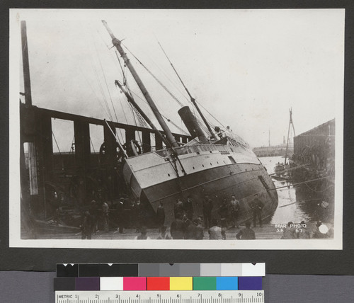 [Toppled steamship in dock.]