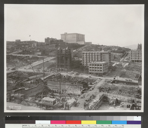 [View looking northwest toward Nob Hill from above circa Stockton and Geary Sts. during reconstruction. Union Square, lower left; Temple Emanu-el, right center; Fairmont Hotel atop hill.]