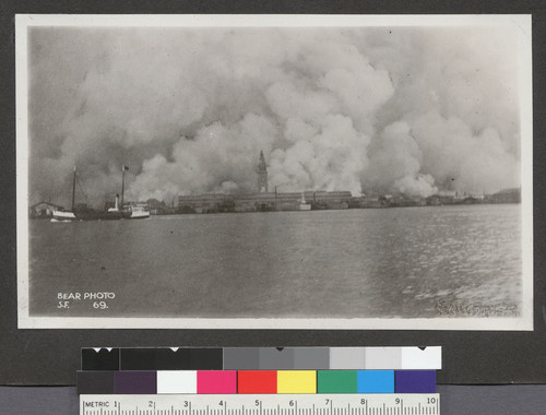 [View of city burning from San Francisco Bay. Ferry Building, center.]