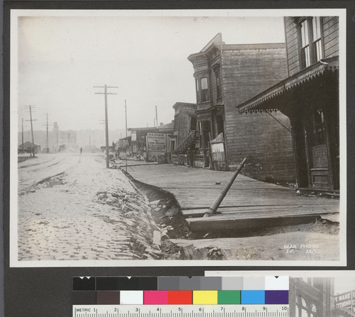 [Earthquake damage to street and sidewalk. Unidentified location.]