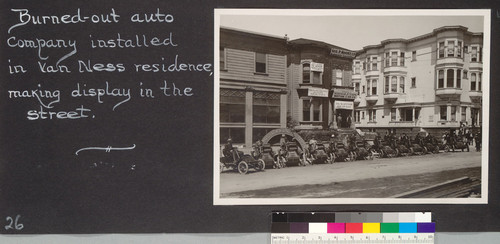 Burned-out auto company installed in Van Ness residence, making display in the street