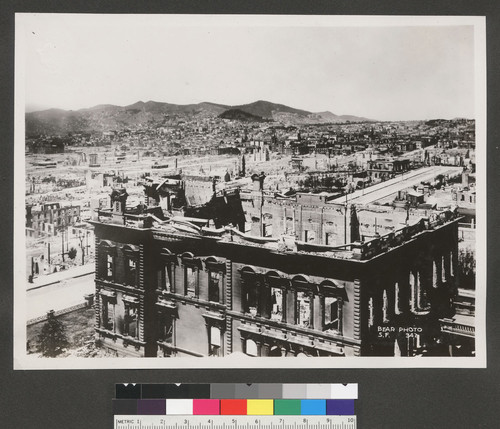 [Panoramic view of city from atop Fairmont Hotel. View looking southwest from Nob Hill. Flood mansion, foreground; Twin Peaks in distance, left center.]