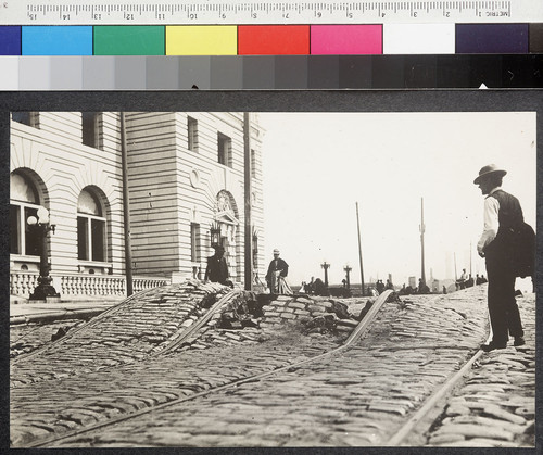 [View of damaged street and rails. U.S. Post Office at Seventh and Mission Sts. in background.]