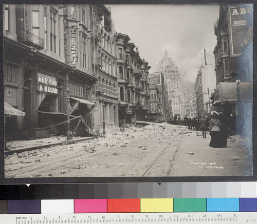 [View along O'Farrell St. looking southeast toward Market St. Call Building burning in distance.]