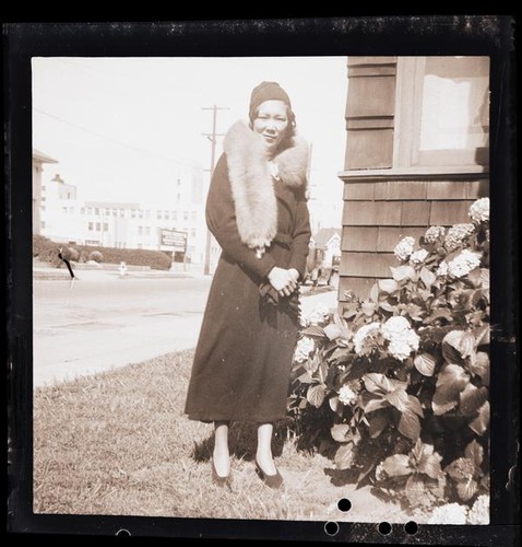 [Unidentified woman on sidewalk]