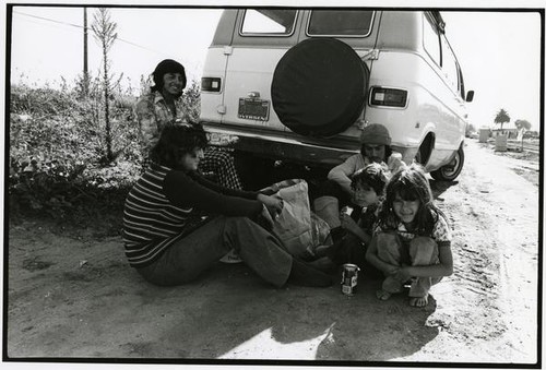 Migrant farm worker family eating lunch