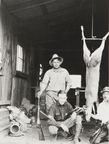 Al Silva, Art Marshall and Yoshio "George" Nagano after successful hunt. Morro Bay : 1927. Note abalone diving gear and helmet on floor