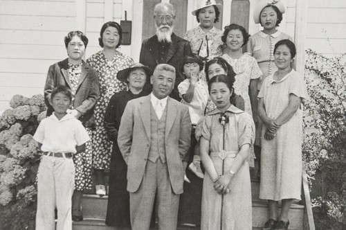 Japanese Methodist Church, A Street, Oxnard : 1937. Clockwise from far left around outside: Calvin Machida, Mrs. Yasuye Takasugi, Mrs. Machida, Rev. K Babu (founder and first minister of church), Mrs. Yamada, Faye Hirata, Tsuruka Yamada, Mrs. Kawata, Mrs. Mano & Mr. Mano. In middle on left: Mrs. Otani (wearing hat), woman holding child not identified