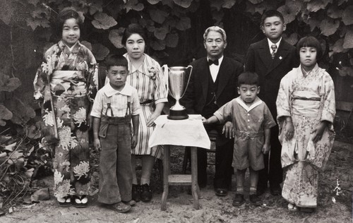 The Moriwaki Family of Oxnard: about 1934 ; back L-R: Masako, Masano (mother), Tokutaro (father), Norio ; Front: Noriyoshi, Takanori, Masami ; the trophy was presented to Mr. Moriwaki when he was President of Oxnard Buddhist Church