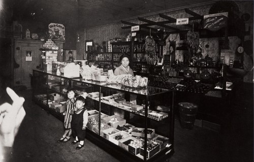 T. Moriwaki Store : 716 Oxnard Boulevard, Oxnard : 1931 ; Masano Moriwaki behind showcase ; children Masami and Noriyoshi