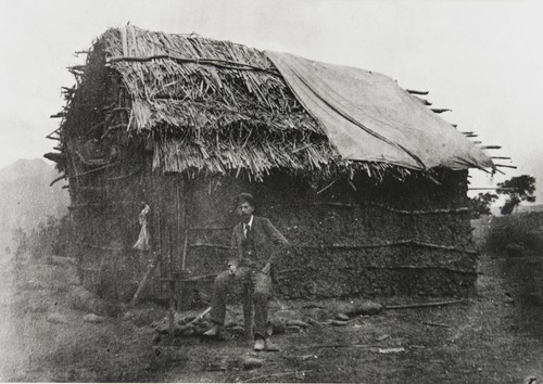 Gabled tule house occupied by an Indian family along the Ventura River near Camp Comfort on the road to Ojai : about 1880