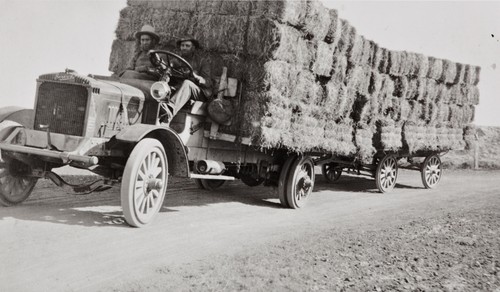 Eulogio Ortega, (at viewer's left), son of Antonia María and Isidora Ortega, on hay truck