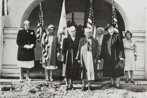 Mary Ann Hall (right center) and other members of the Santa Barbara Chapter of the American Gold Star Mothers at the National Guard Armory, planting roses in memory of soldiers who had died during the two World Wars : ca. 1948. Mrs. Hall's son, Jasper E. Hall, died in combat in World War I