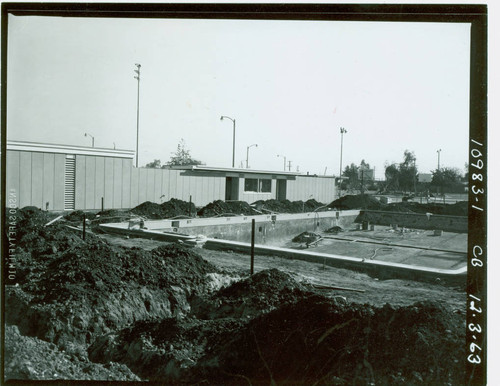 View of construction of the swimming pool and pool house at Enterprise Park