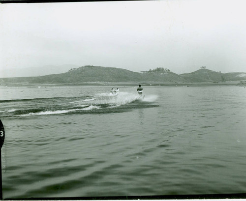 View of water skiers on Puddingstone Lake at Frank G. Bonelli Regional Park