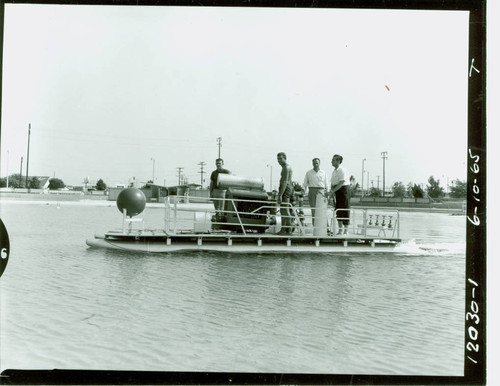 View of pool cleaning boat in action at Alondra Park