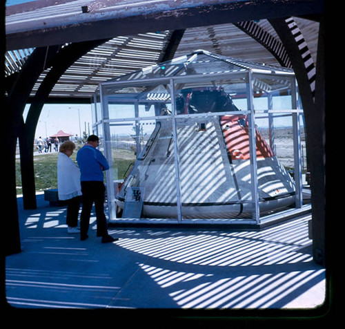 View of visitors viewing the Apollog scale model space capsule at Apollo Park